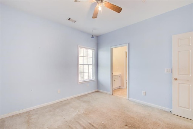 unfurnished room with light carpet, visible vents, a ceiling fan, and baseboards