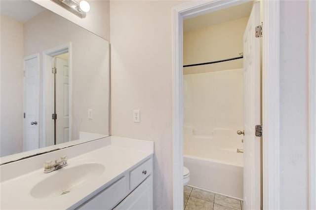 full bathroom featuring toilet, bathtub / shower combination, vanity, and tile patterned flooring