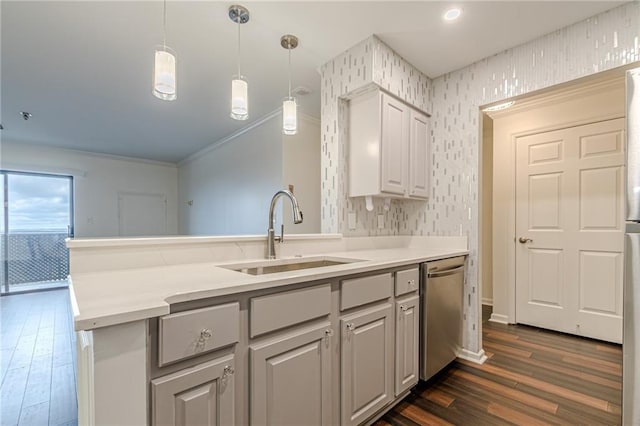 kitchen with dishwasher, sink, hanging light fixtures, ornamental molding, and dark hardwood / wood-style flooring