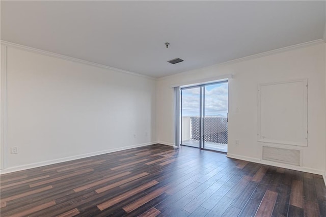 empty room featuring dark hardwood / wood-style flooring and ornamental molding