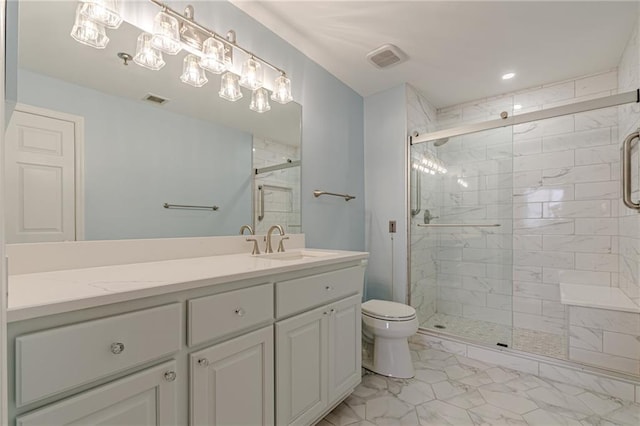 bathroom with vanity, toilet, and a shower with shower door