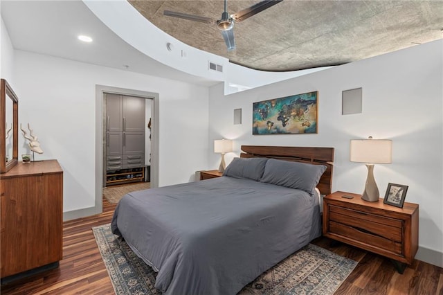 bedroom featuring wood finished floors, baseboards, a ceiling fan, recessed lighting, and connected bathroom