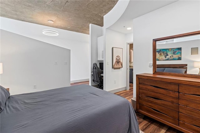 bedroom with wood finished floors, recessed lighting, and baseboards