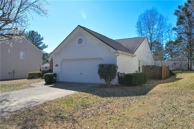 view of property exterior featuring driveway and an attached garage