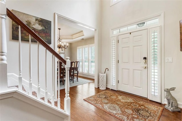4401 Madison Woods Dr NW, Marietta, GA 30064 - foyer entrance featuring a chandelier, wood finished floors, stairway, and a tray ceiling