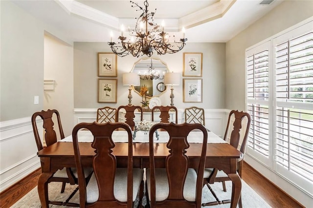 4401 Madison Woods Dr NW, Marietta, GA 30064 - dining area with a chandelier, wood finished floors, a tray ceiling, a decorative wall, and crown molding