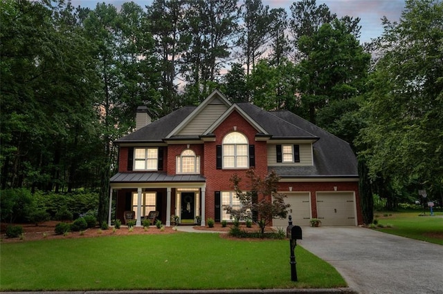4401 Madison Woods Dr NW, Marietta, GA 30064 - view of front facade with a porch, concrete driveway, a front yard, a chimney, and brick siding