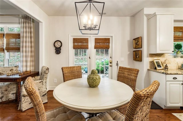 4401 Madison Woods Dr NW, Marietta, GA 30064 - dining space featuring dark wood-style flooring, healthy amount of natural light, and a chandelier