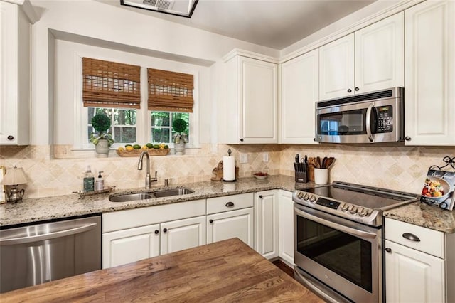 4401 Madison Woods Dr NW, Marietta, GA 30064 - kitchen featuring stainless steel appliances, tasteful backsplash, and white cabinets