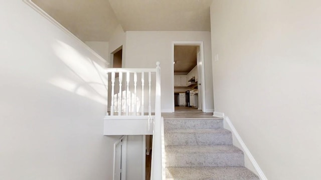 staircase featuring baseboards