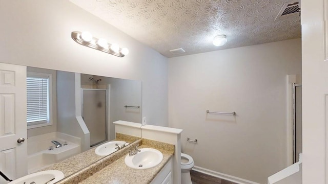 full bathroom featuring a stall shower, visible vents, a sink, and double vanity