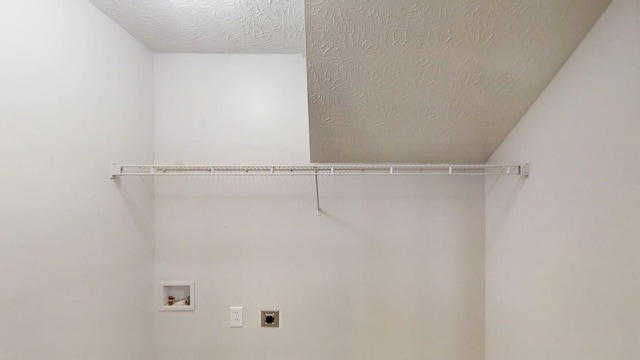 washroom featuring laundry area, hookup for a washing machine, hookup for an electric dryer, and a textured ceiling