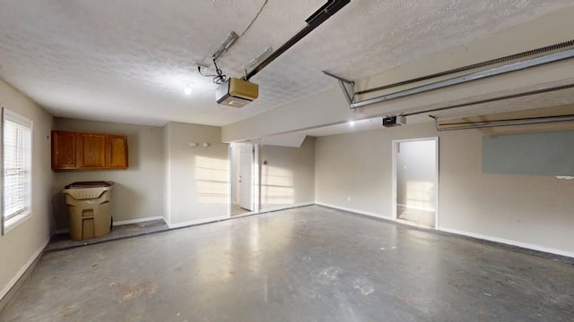 garage with a garage door opener and baseboards