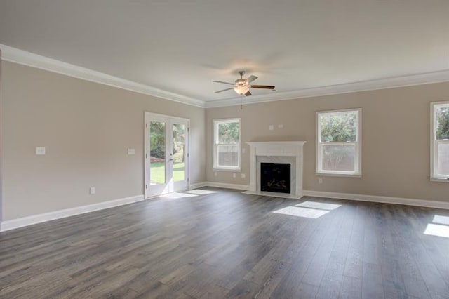 unfurnished living room featuring french doors, ornamental molding, a high end fireplace, and dark hardwood / wood-style flooring