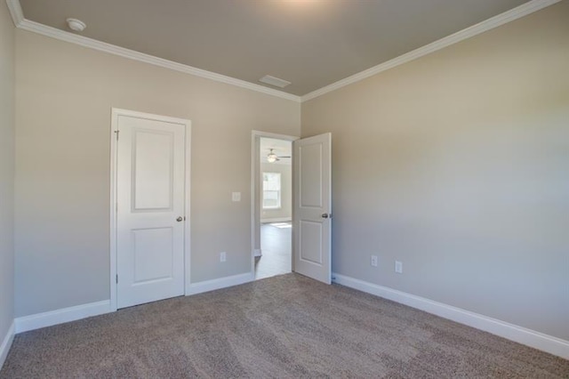 unfurnished bedroom with crown molding and light colored carpet