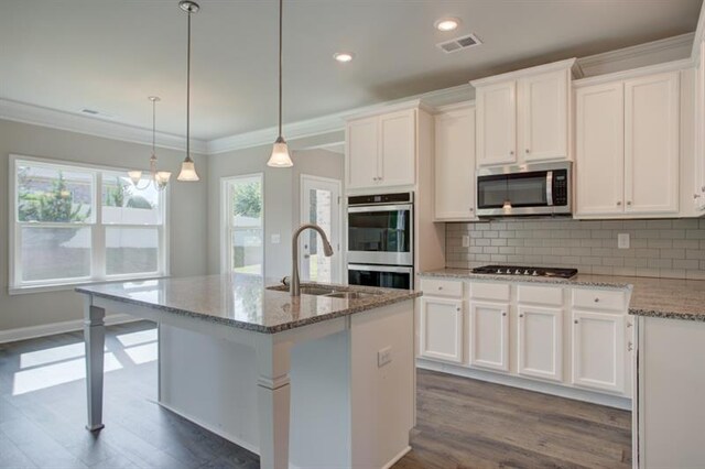 unfurnished dining area featuring ornamental molding, dark wood-type flooring, and an inviting chandelier