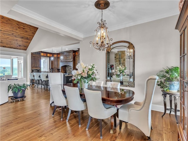 702 Cash Rd NE, Calhoun, GA 30701 - dining room featuring a chandelier, vaulted ceiling, light wood-type flooring, and crown molding