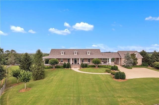 702 Cash Rd NE, Calhoun, GA 30701 - cape cod-style house featuring a front yard, driveway, a porch, and brick siding