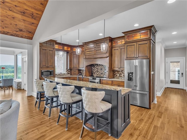 702 Cash Rd NE, Calhoun, GA 30701 - kitchen featuring stainless steel appliances, tasteful backsplash, recessed lighting, light wood finished floors, and light stone countertops