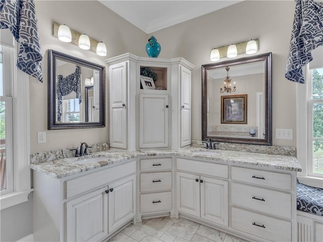 702 Cash Rd NE, Calhoun, GA 30701 - bathroom featuring double vanity, a chandelier, and marble look tile flooring