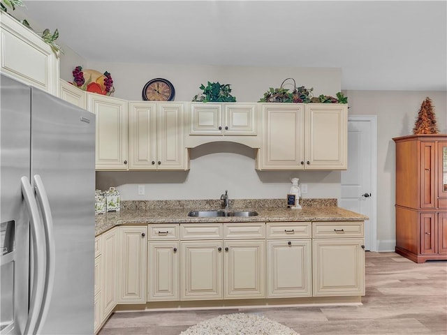 702 Cash Rd NE, Calhoun, GA 30701 - kitchen with stainless steel fridge with ice dispenser, light wood-style floors, and light stone counters
