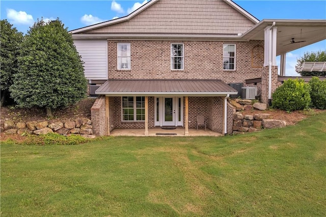 702 Cash Rd NE, Calhoun, GA 30701 - back of house with a lawn, brick siding, a patio area, and a ceiling fan
