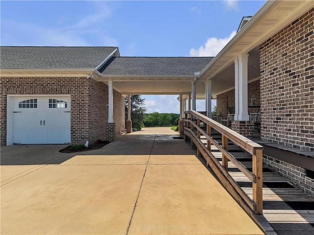 702 Cash Rd NE, Calhoun, GA 30701 - view of side of property featuring concrete driveway, brick siding, a shingled roof, and a garage