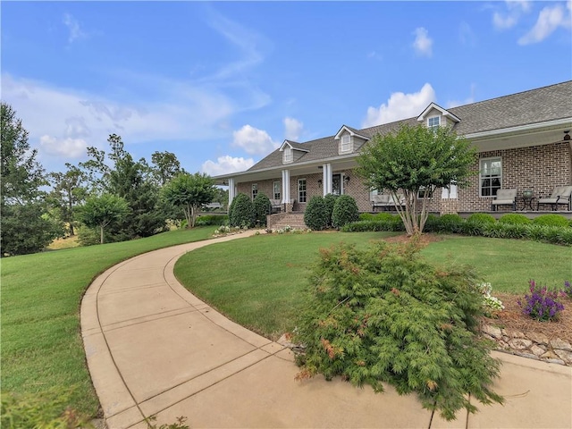 702 Cash Rd NE, Calhoun, GA 30701 - view of front facade featuring brick siding, a front lawn, and covered porch