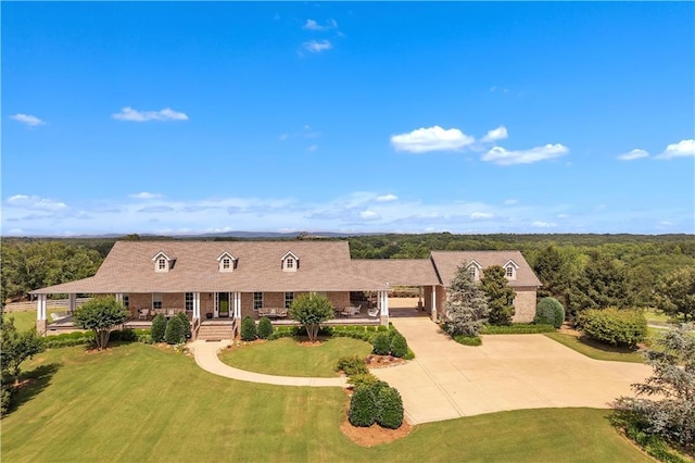702 Cash Rd NE, Calhoun, GA 30701 - new england style home with concrete driveway, a front lawn, covered porch, and brick siding
