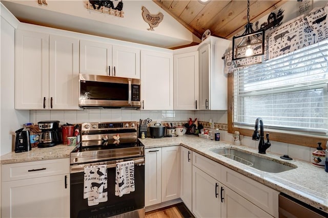 kitchen featuring sink, appliances with stainless steel finishes, hanging light fixtures, light stone countertops, and white cabinets