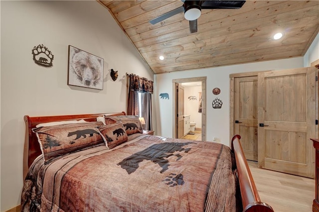 bedroom featuring lofted ceiling, wood ceiling, ensuite bath, light hardwood / wood-style flooring, and ceiling fan