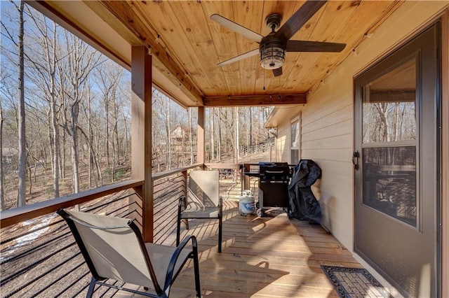 wooden terrace featuring ceiling fan and area for grilling