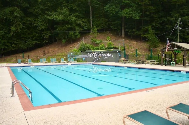 pool featuring a patio and fence