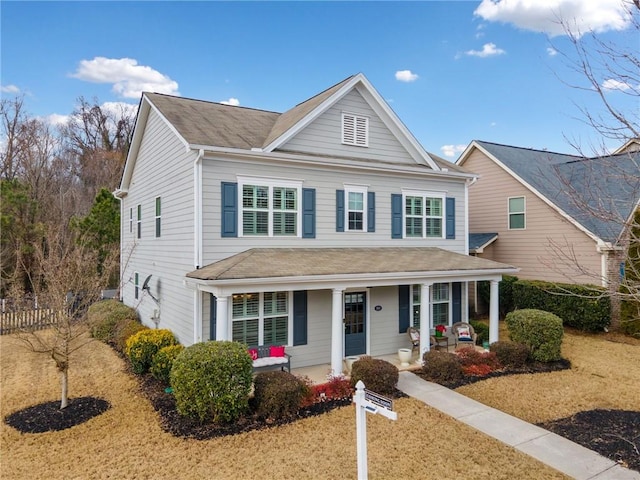 view of front of home with covered porch and a front yard