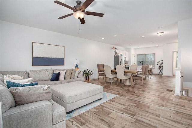 living area featuring light wood-type flooring, visible vents, ceiling fan, and recessed lighting