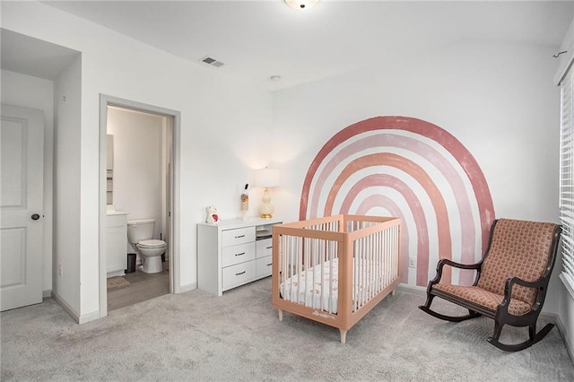 bedroom with light carpet, connected bathroom, visible vents, and baseboards