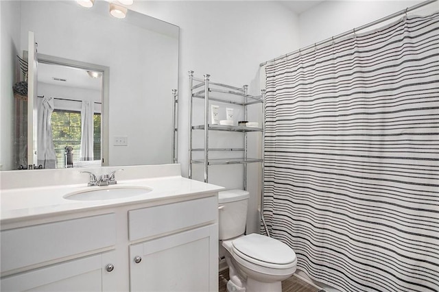 full bathroom with toilet, vanity, and a shower with curtain