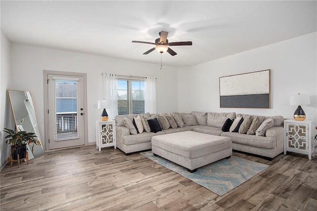 living area featuring light wood-style floors and ceiling fan