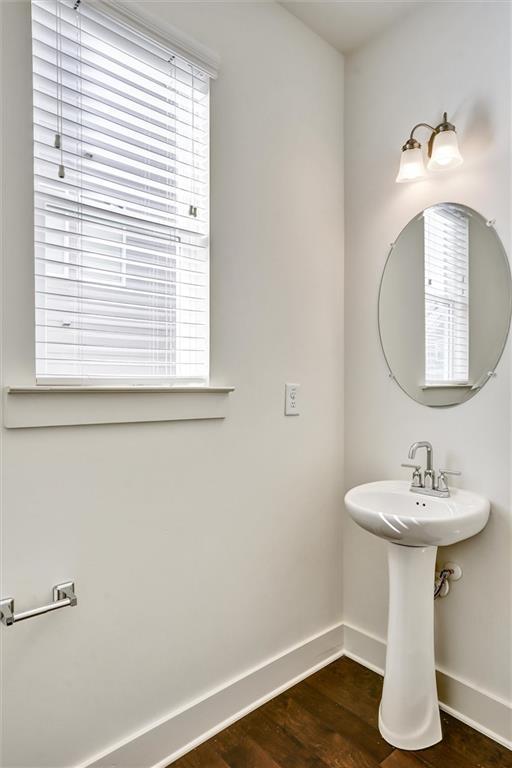 bathroom with baseboards and wood finished floors