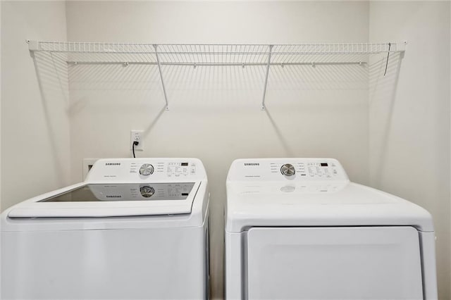 laundry area with laundry area and washer and clothes dryer