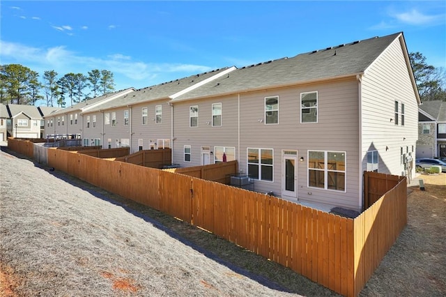 back of house featuring a residential view and fence