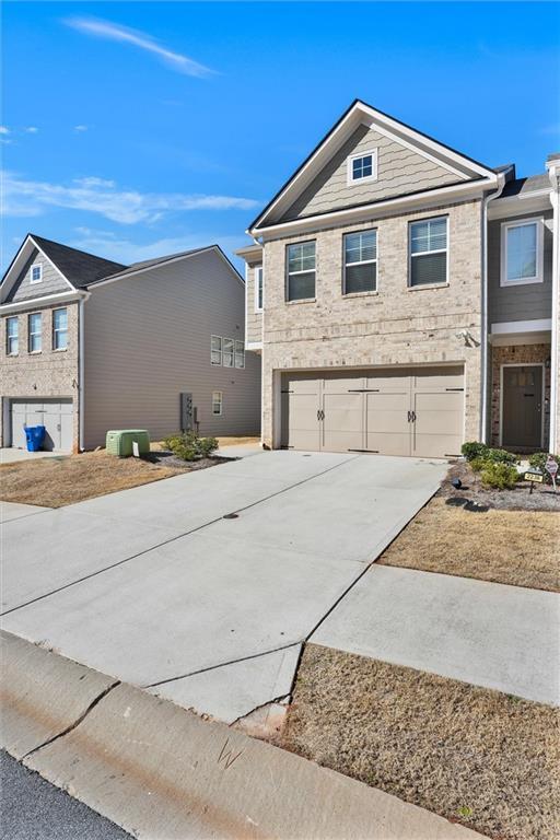 view of front of property with driveway and an attached garage