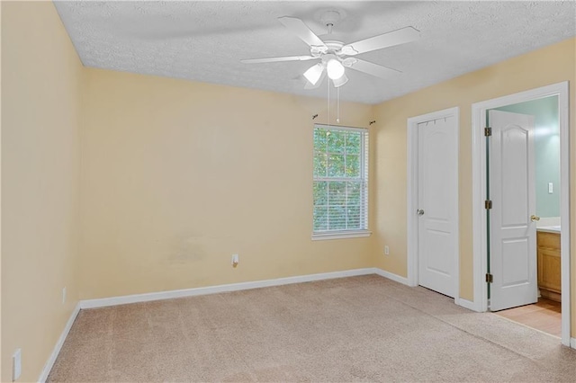3127 Fields Dr, Lithonia, GA 30038 - unfurnished bedroom featuring light carpet, baseboards, a textured ceiling, and ceiling fan