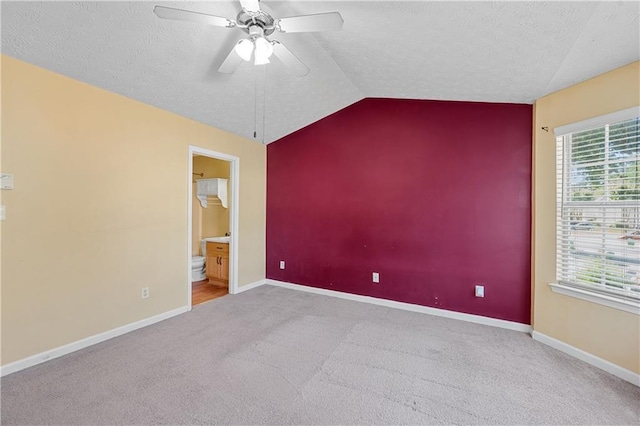 3127 Fields Dr, Lithonia, GA 30038 - unfurnished bedroom with lofted ceiling, carpet flooring, baseboards, a textured ceiling, and ensuite bathroom