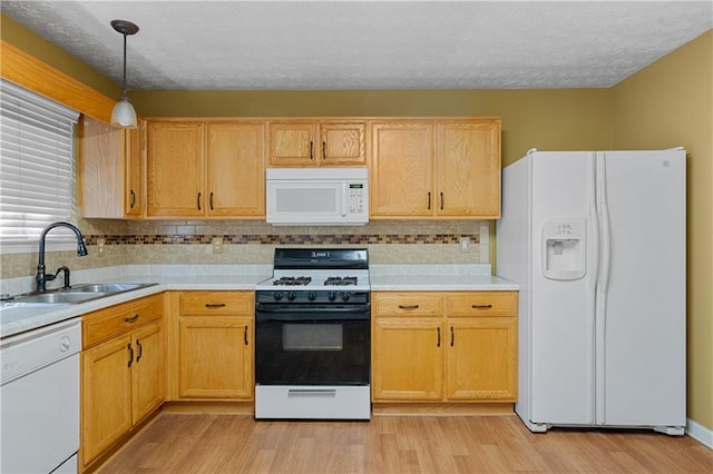 3127 Fields Dr, Lithonia, GA 30038 - kitchen featuring white appliances, a sink, light countertops, light wood-type flooring, and a textured ceiling