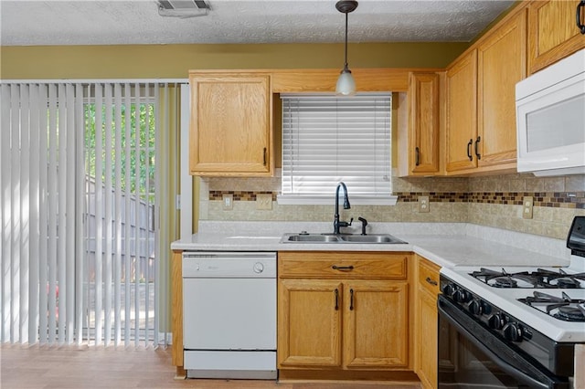 3127 Fields Dr, Lithonia, GA 30038 - kitchen featuring white appliances, a sink, light countertops, and tasteful backsplash