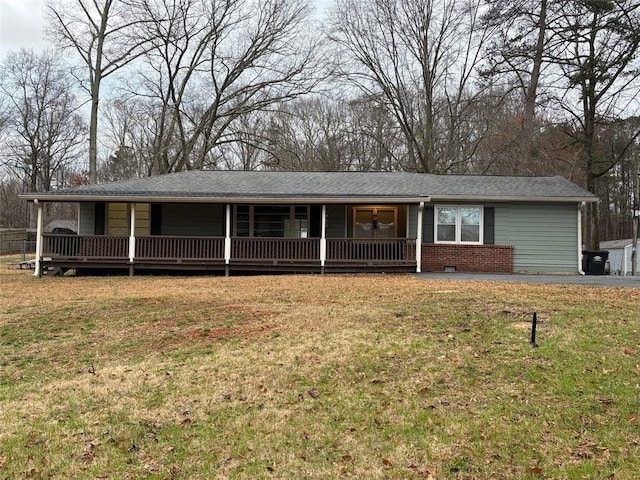 ranch-style house featuring crawl space, a porch, a front lawn, and brick siding