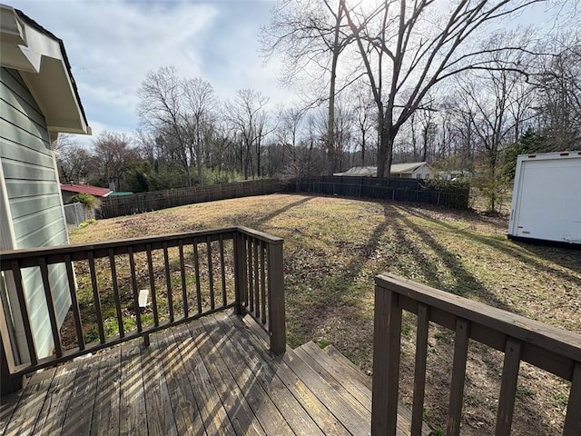 wooden terrace with a fenced backyard