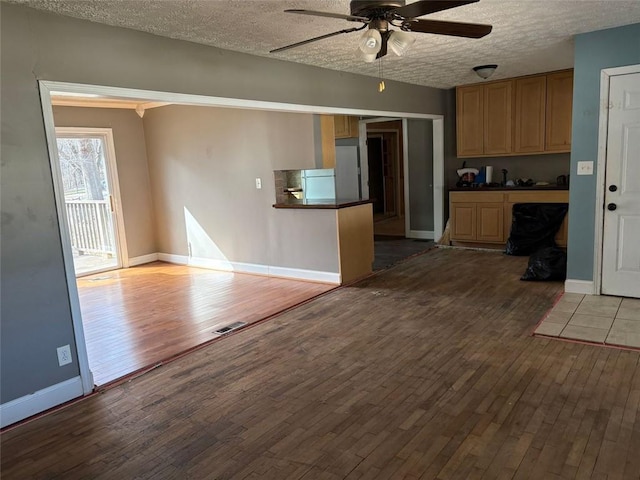 kitchen with dark countertops, visible vents, and wood finished floors