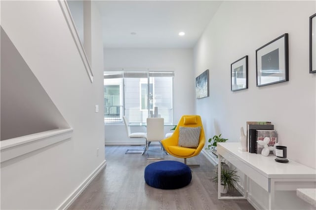 living area with baseboards, recessed lighting, and wood finished floors